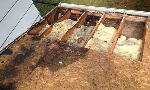Old and rotting roof sheeting in the process of being replaced by Excalibur Roofing