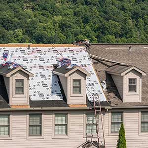 Brown residential roof getting its shingles replaced with new GAF shingles